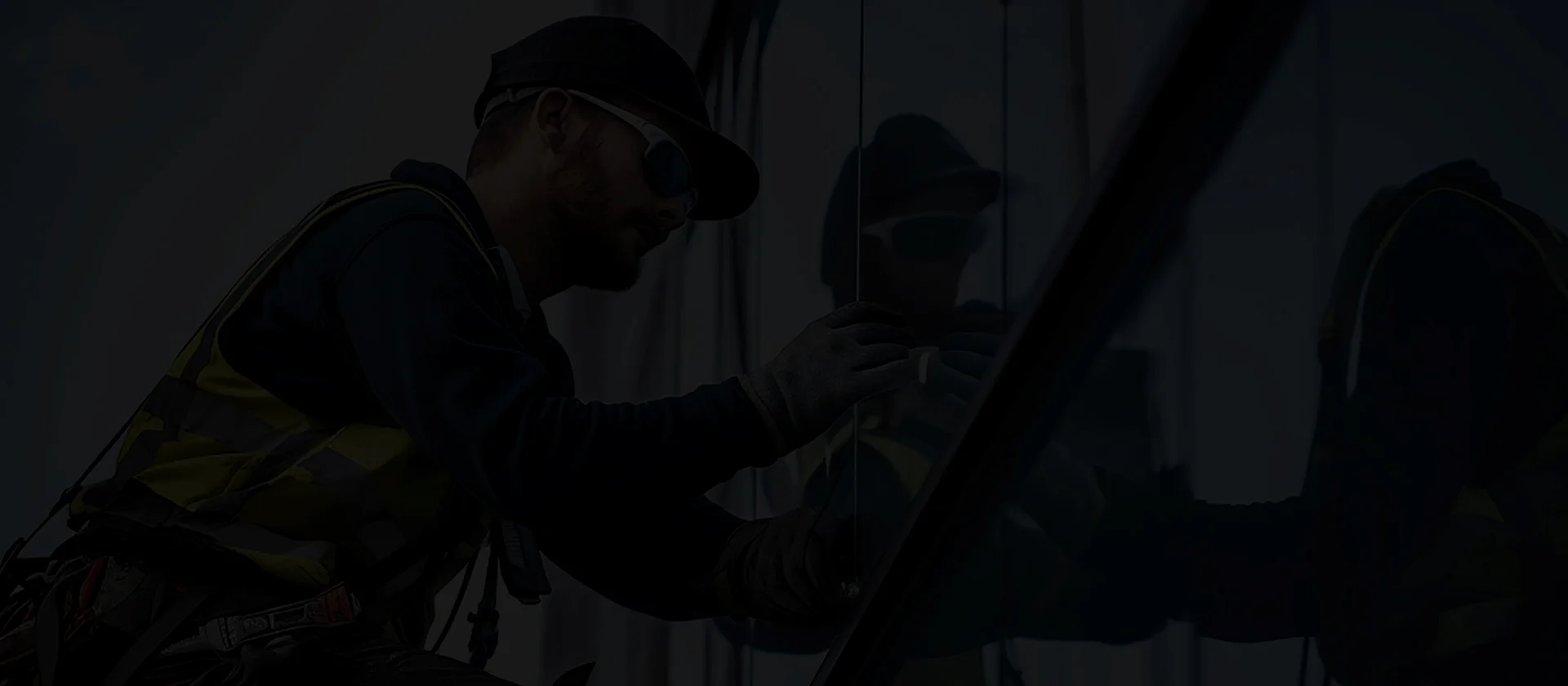 Dr SunShield technician applying ceramic window film to car glass in Dubai